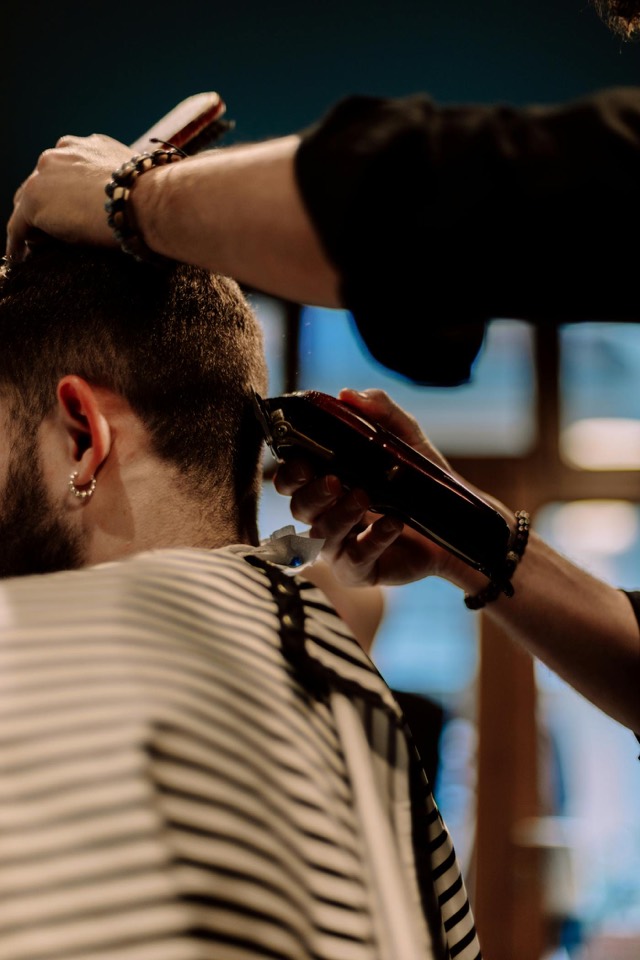 Client receiving haircut and beard trim in one service
